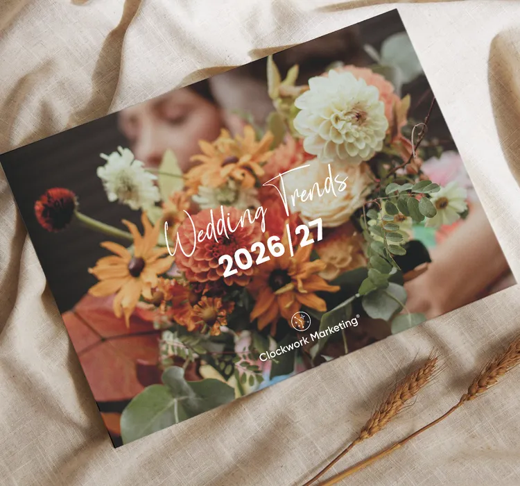 Wedding Trends 2026/27 magazine cover with a bouquet of orange, white, and yellow flowers on a fabric background.