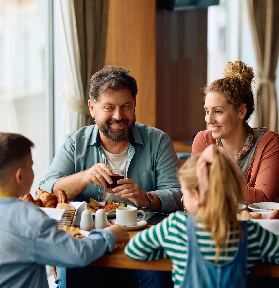 Family enjoying breakfast together at a restaurant.