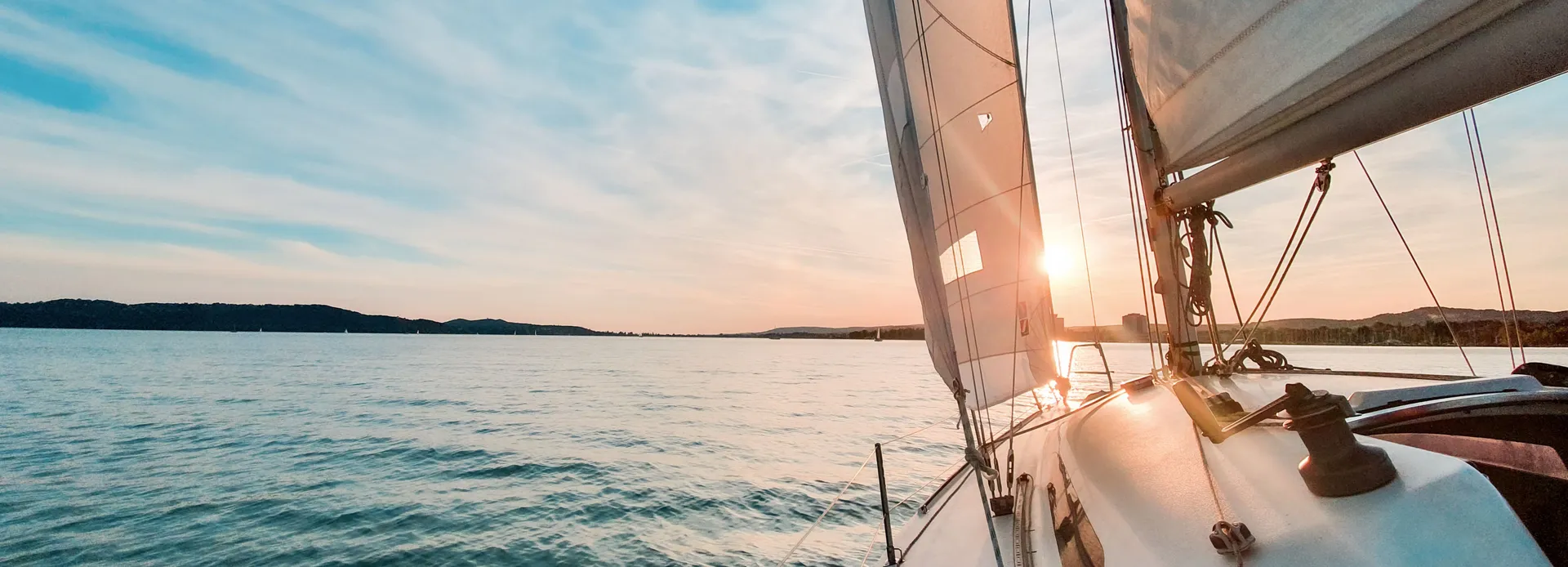 Sailboat on calm water at sunset