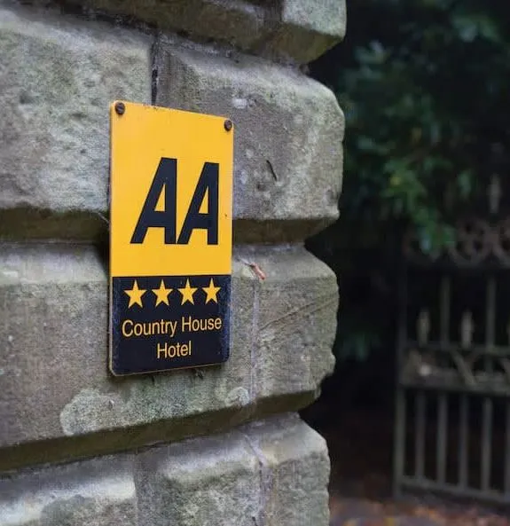 AA-rated country house hotel sign mounted on a stone wall