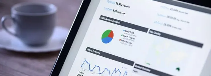 Tablet screen displaying website analytics dashboard with charts and graphs