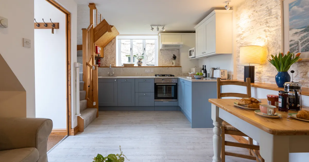 The dairy kitchen with blue cabinets and dining table