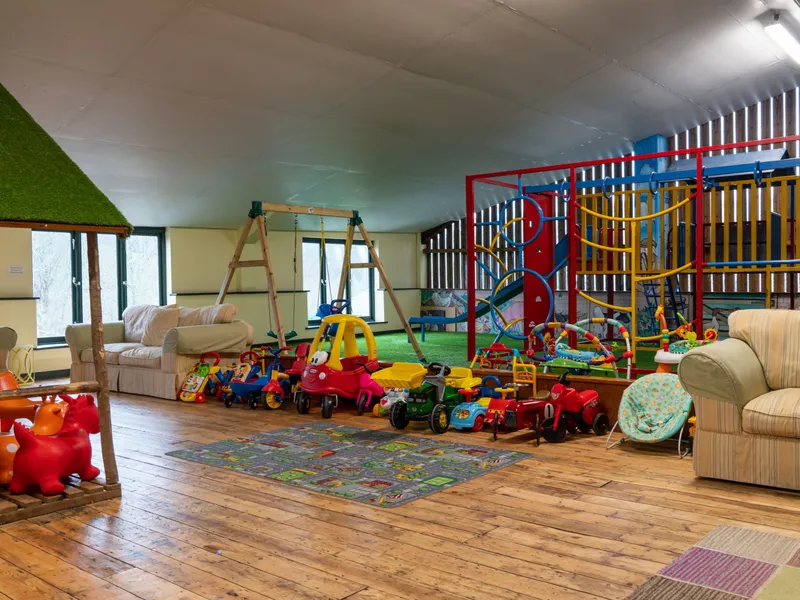 indoor play barn with climbing frame and push cars