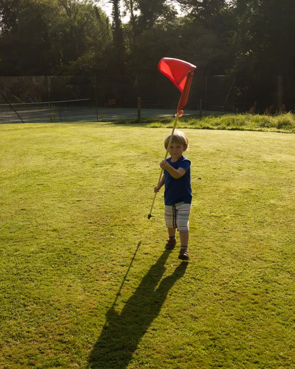 Child holding flag on Pitch and Putt