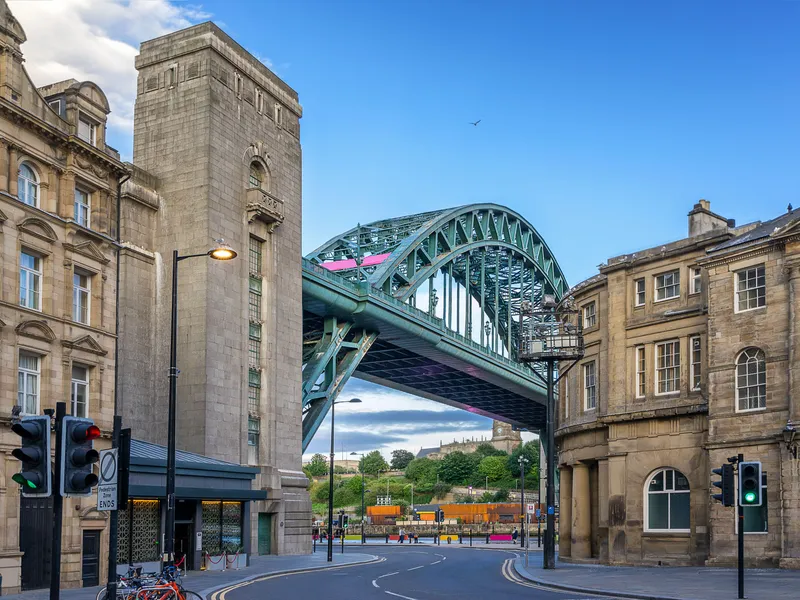 Tyne Bridge spanning a street between historic stone buildings in Newcastle upon Tyne