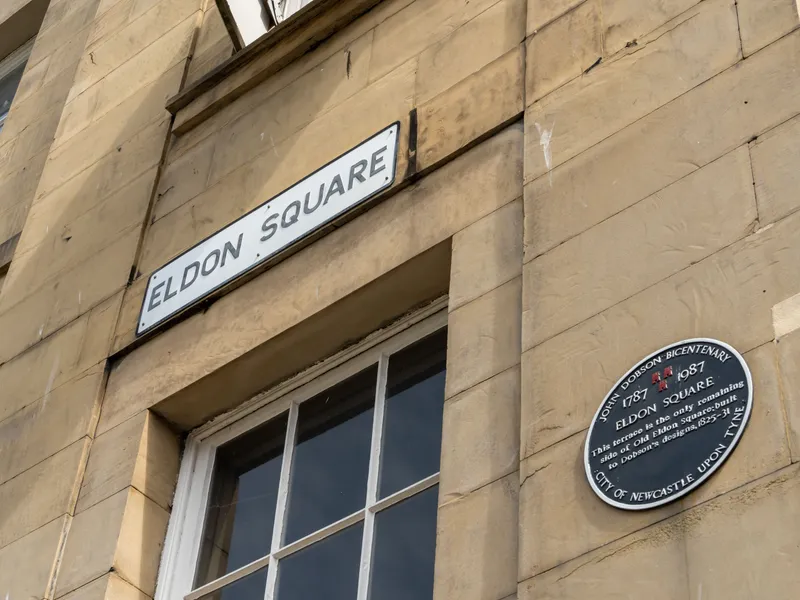 Eldon Square street sign and commemorative plaque on a sandstone building in Newcastle upon Tyne