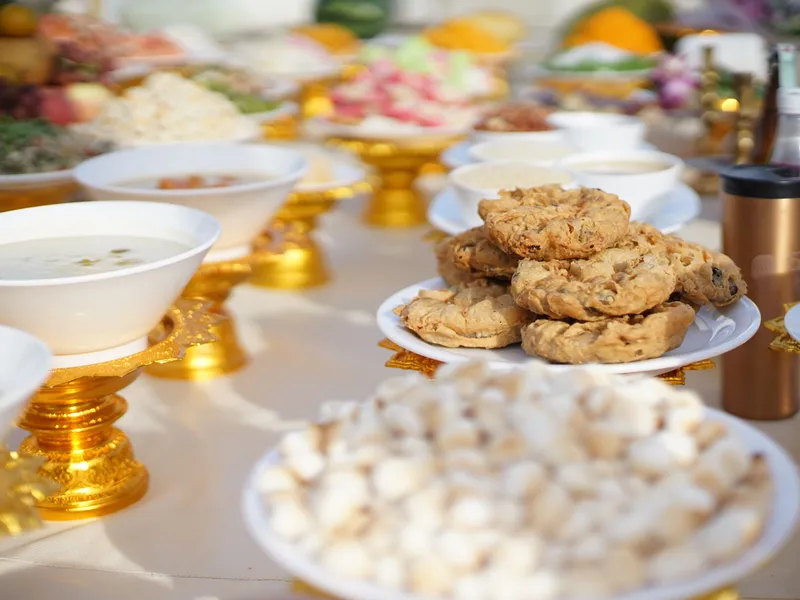 Plate of golden-brown biscuits on a buffet table with bowls of soup and other dishes