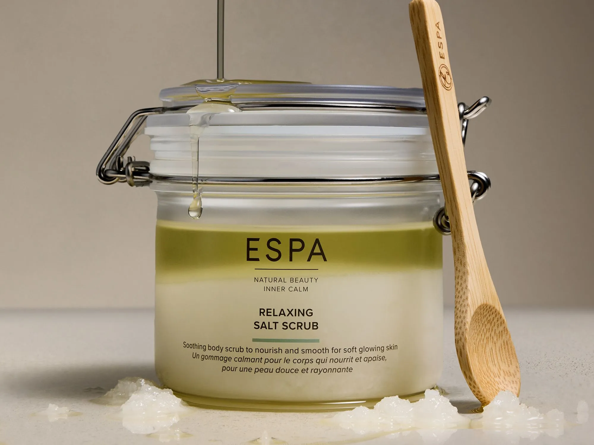 ESPA Relaxing Salt Scrub jar with wooden spoon and dripping oil