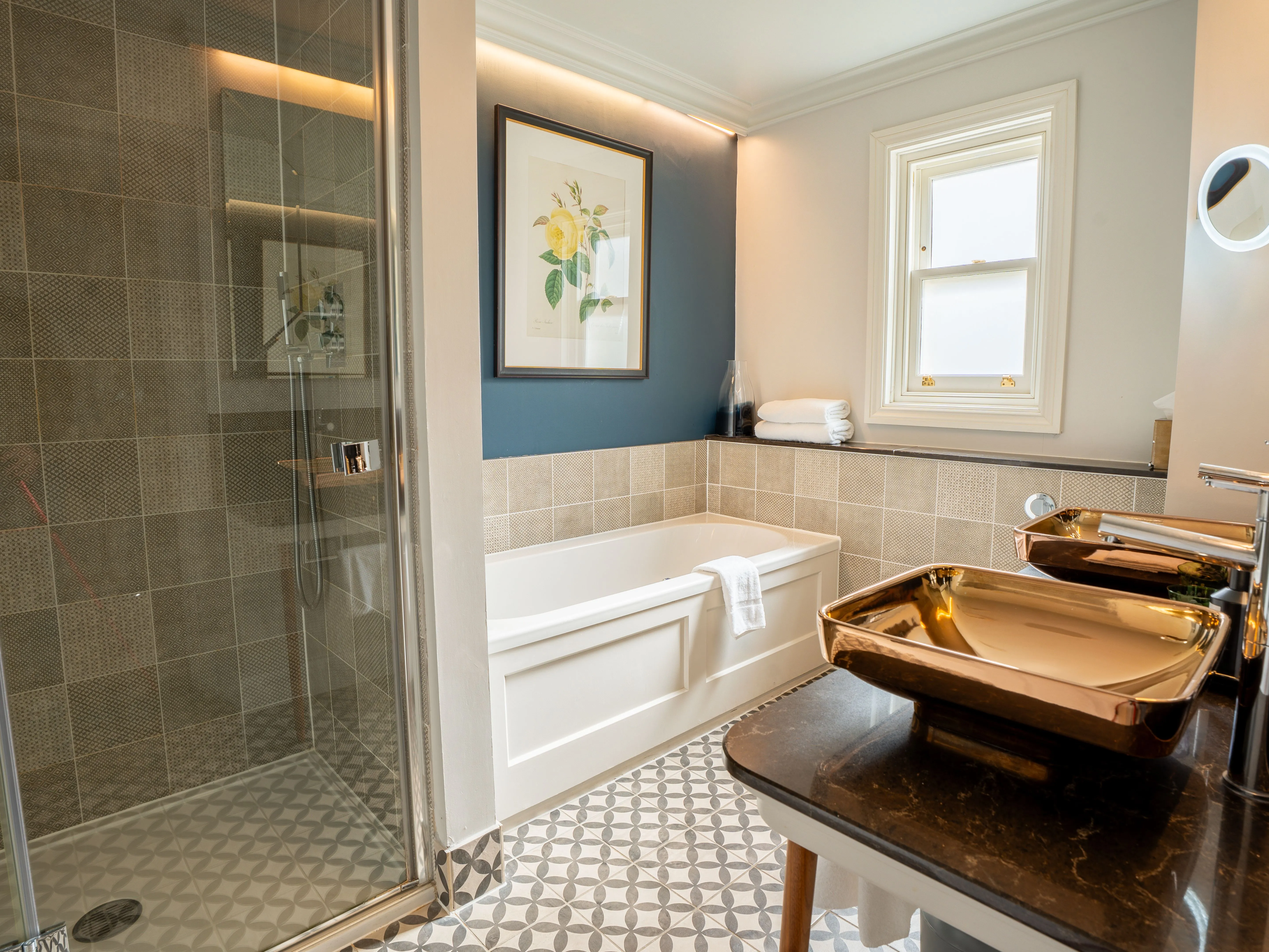 Modern bathroom with walk-in shower, bathtub and metallic basin sink