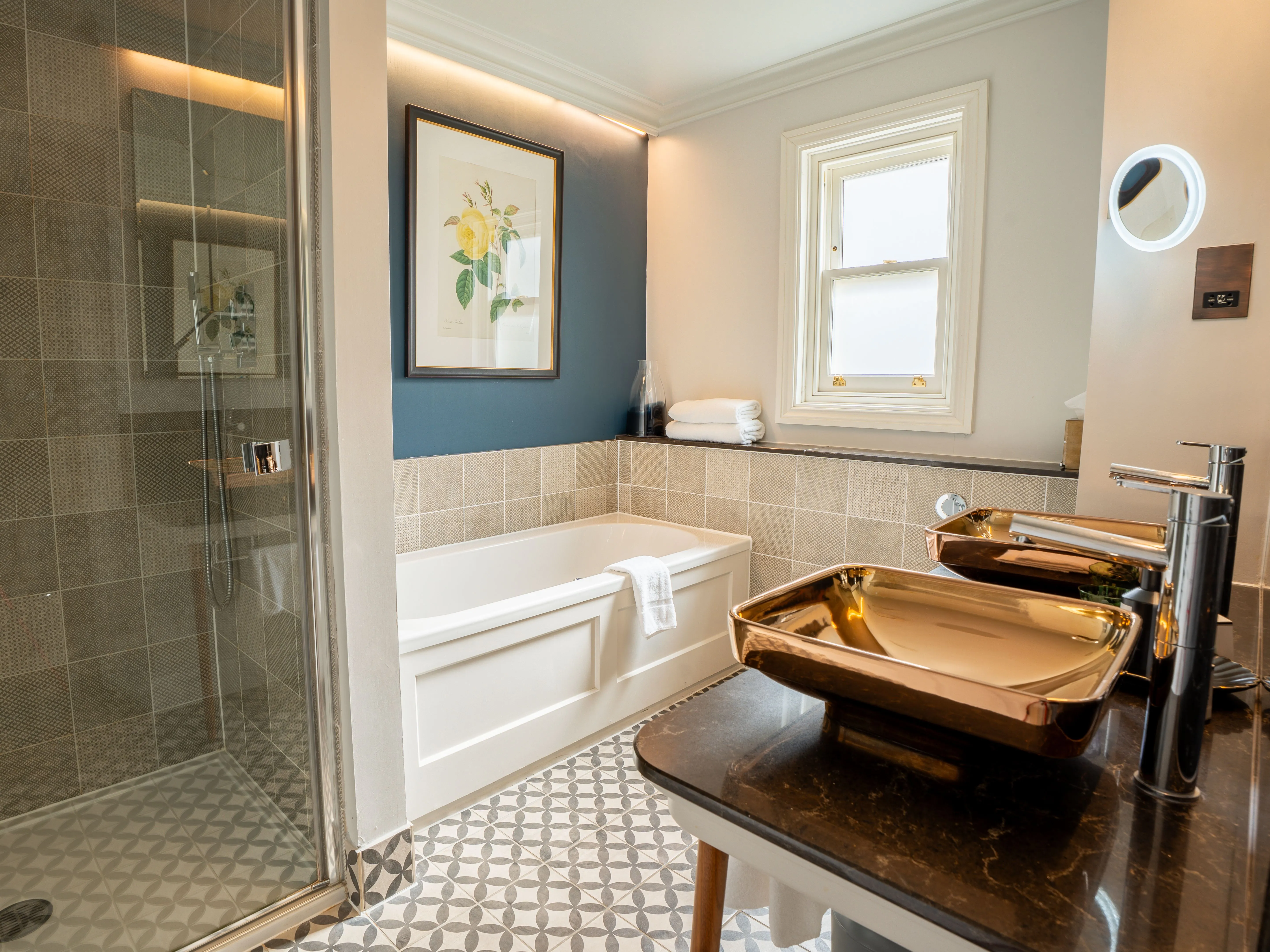 Modern bathroom with walk-in shower, bathtub and metallic basin sink