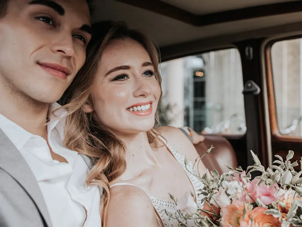 Bride and groom in car