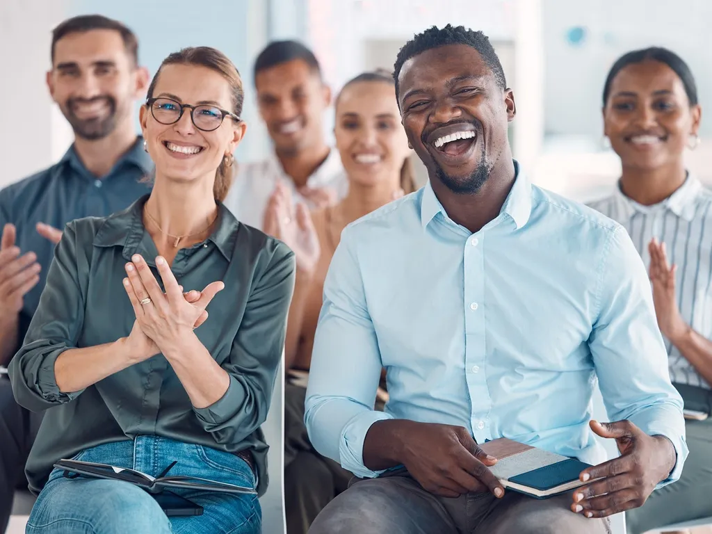 Group of people sat down laughing