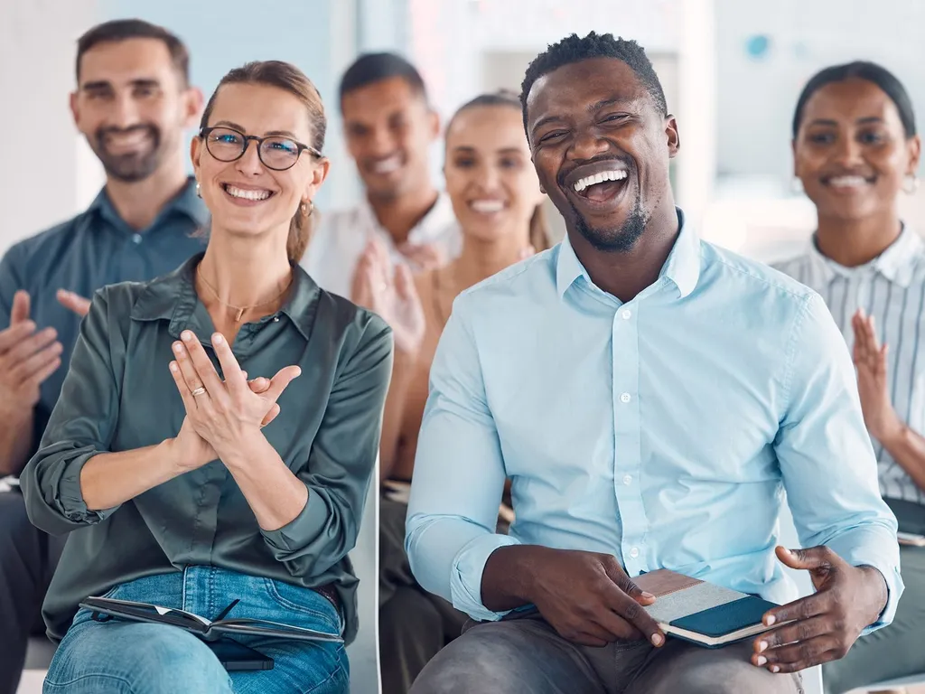 Group of people sat down laughing
