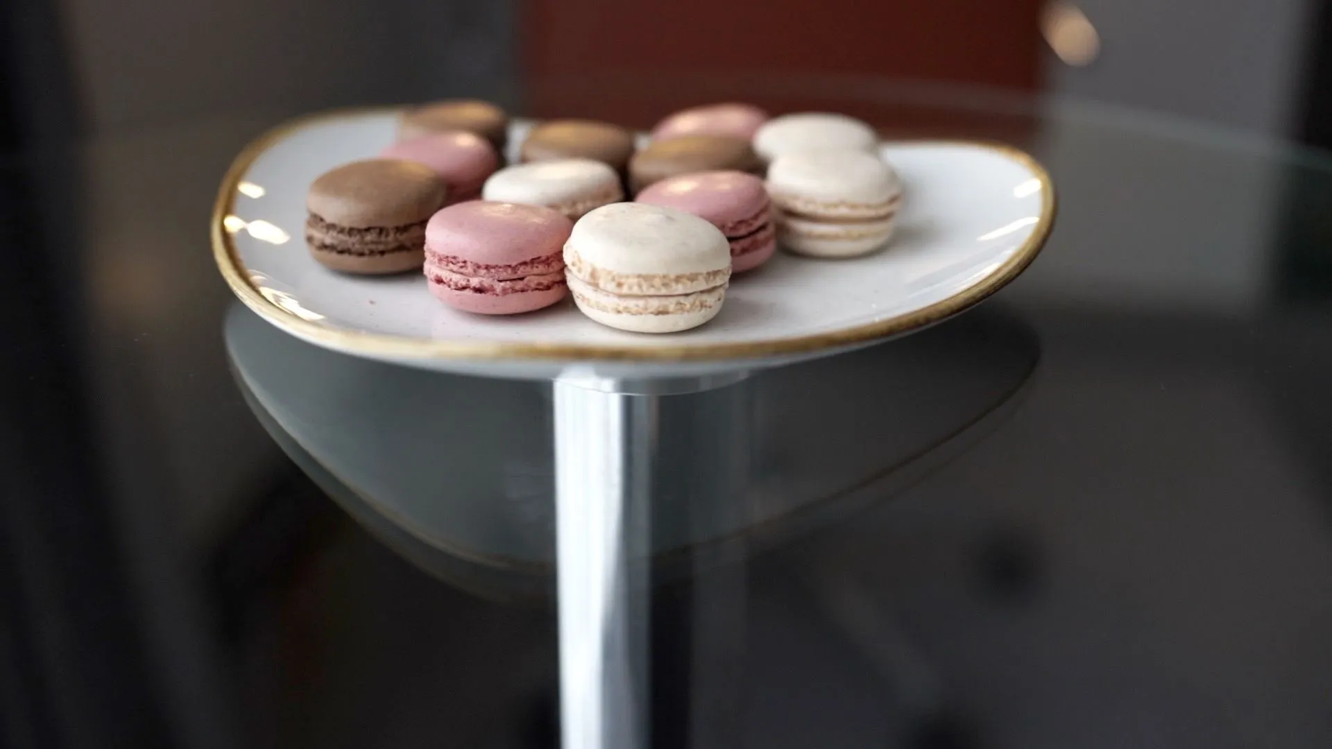 Plate of assorted macarons on a glass table at Holiday Inn Newcastle Gosforth Park
