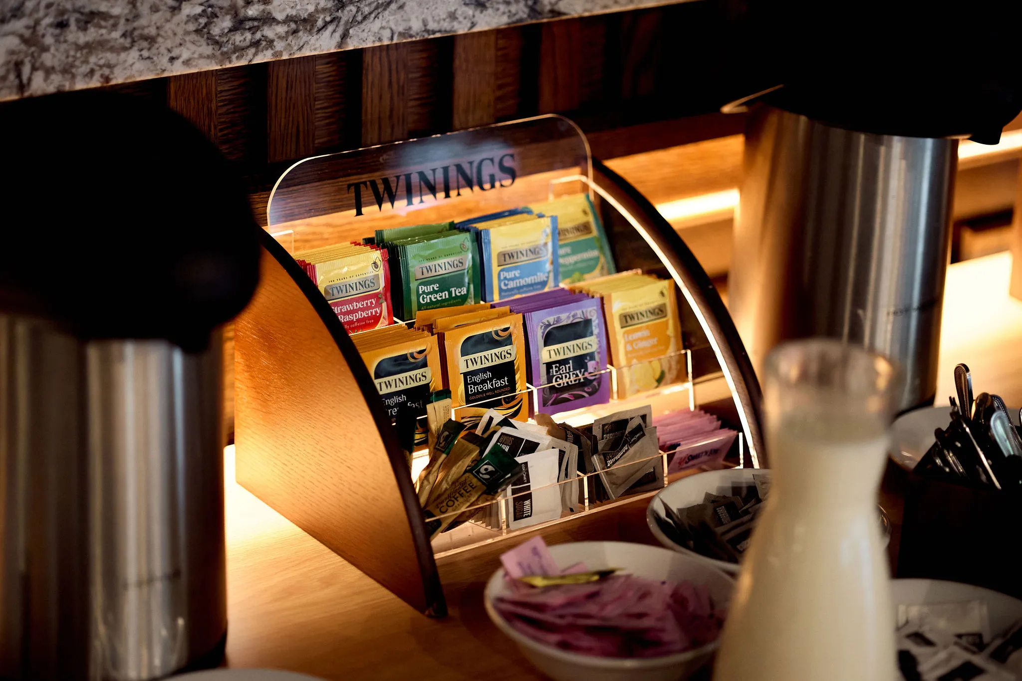 Twinings tea selection and hot drink station on a wooden counter