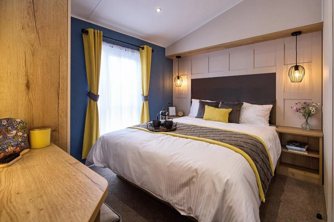 Modern bedroom with double bed, mustard curtains, and pendant lights