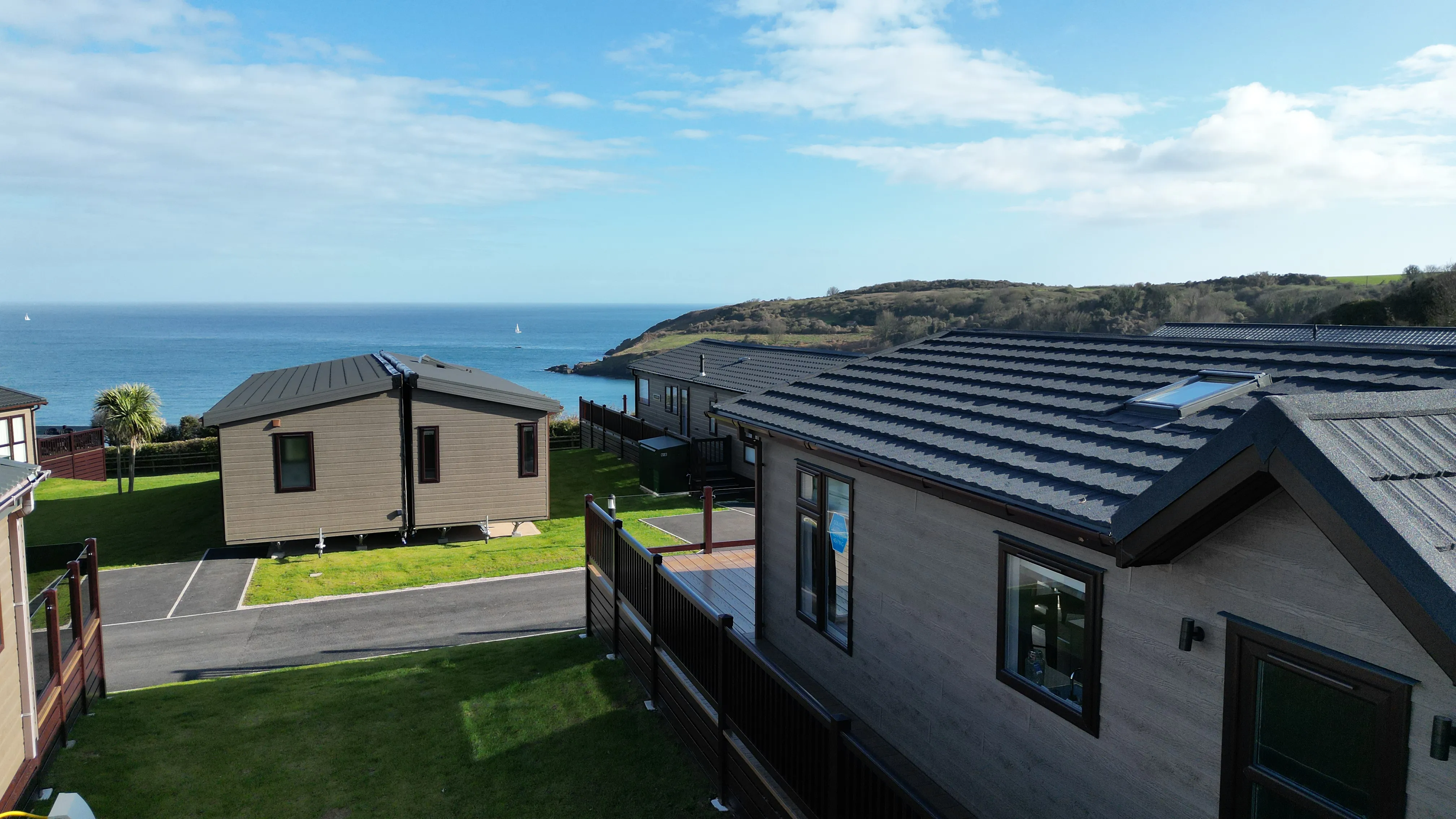 Coastal holiday lodges overlooking the sea on a sunny day