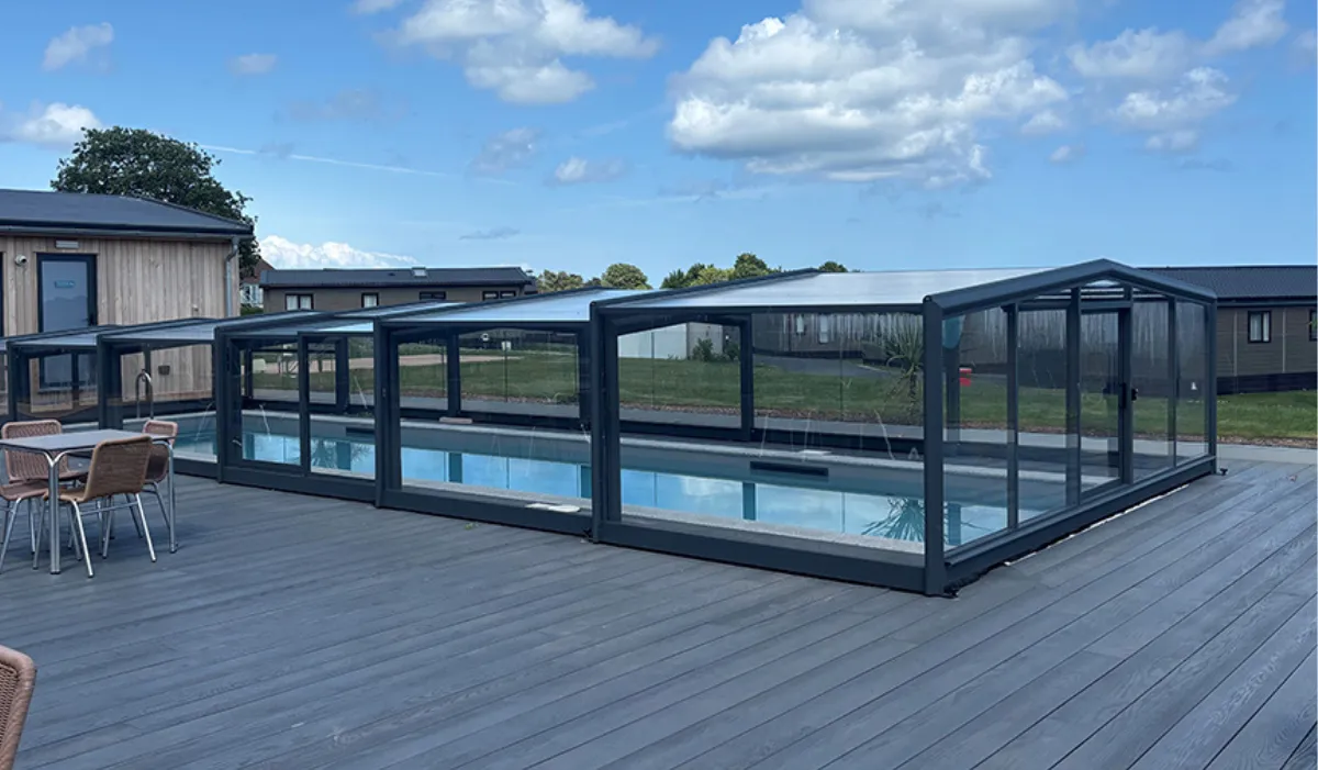 Outdoor swimming pool with a modern retractable enclosure on a spacious deck at Riviera Bay