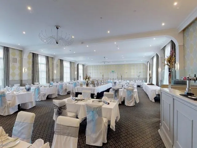 Elegant function room at Palmers Restaurant set for a formal event with white tablecloths and chair covers