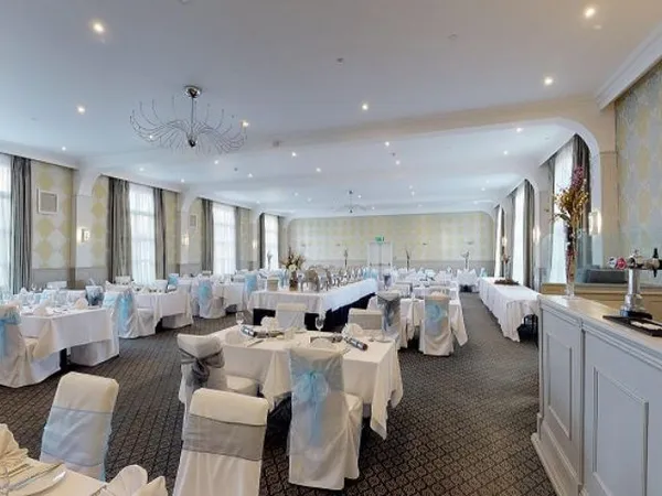Elegant function room at Palmers Restaurant set for a formal event with white tablecloths and chair covers