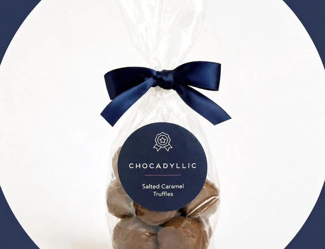 Bag of Chocadyllic salted caramel truffles tied with a navy ribbon