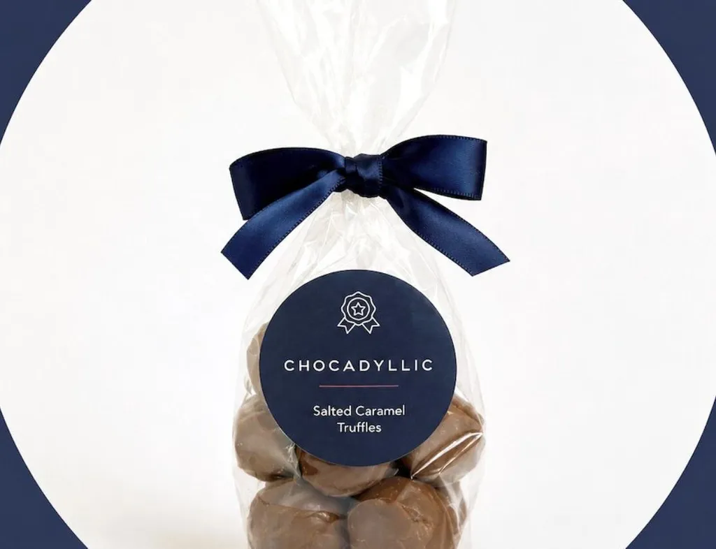 Bag of Chocadyllic salted caramel truffles tied with a navy ribbon