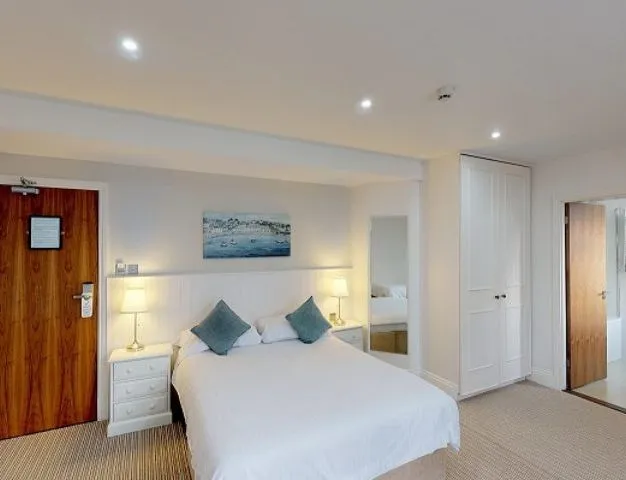 Classic hotel bedroom with a double bed, bedside tables, wardrobe and en-suite bathroom