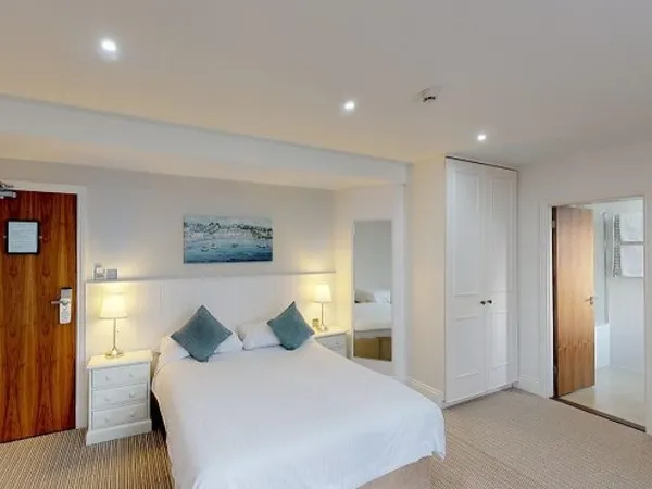 Classic hotel bedroom with a double bed, bedside tables, wardrobe and en-suite bathroom