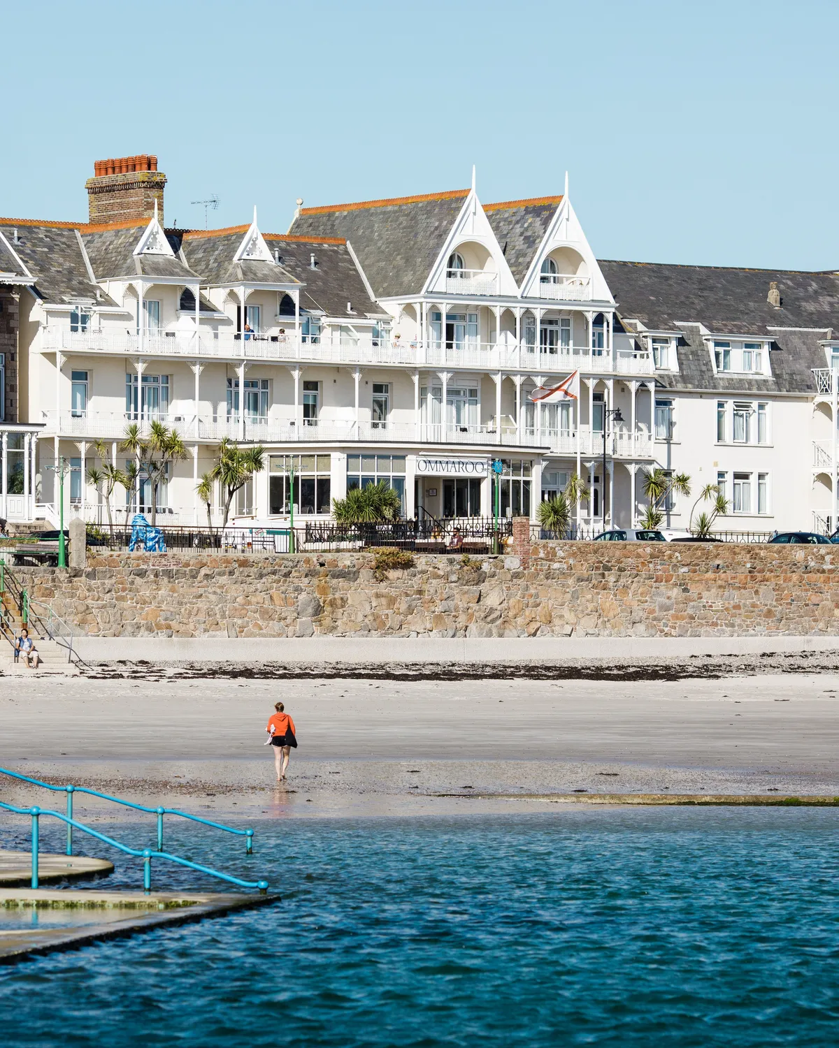 General view of Havre des Pas seafront with beachfront hotel buildings, sandy shore and sea pool steps in Jersey