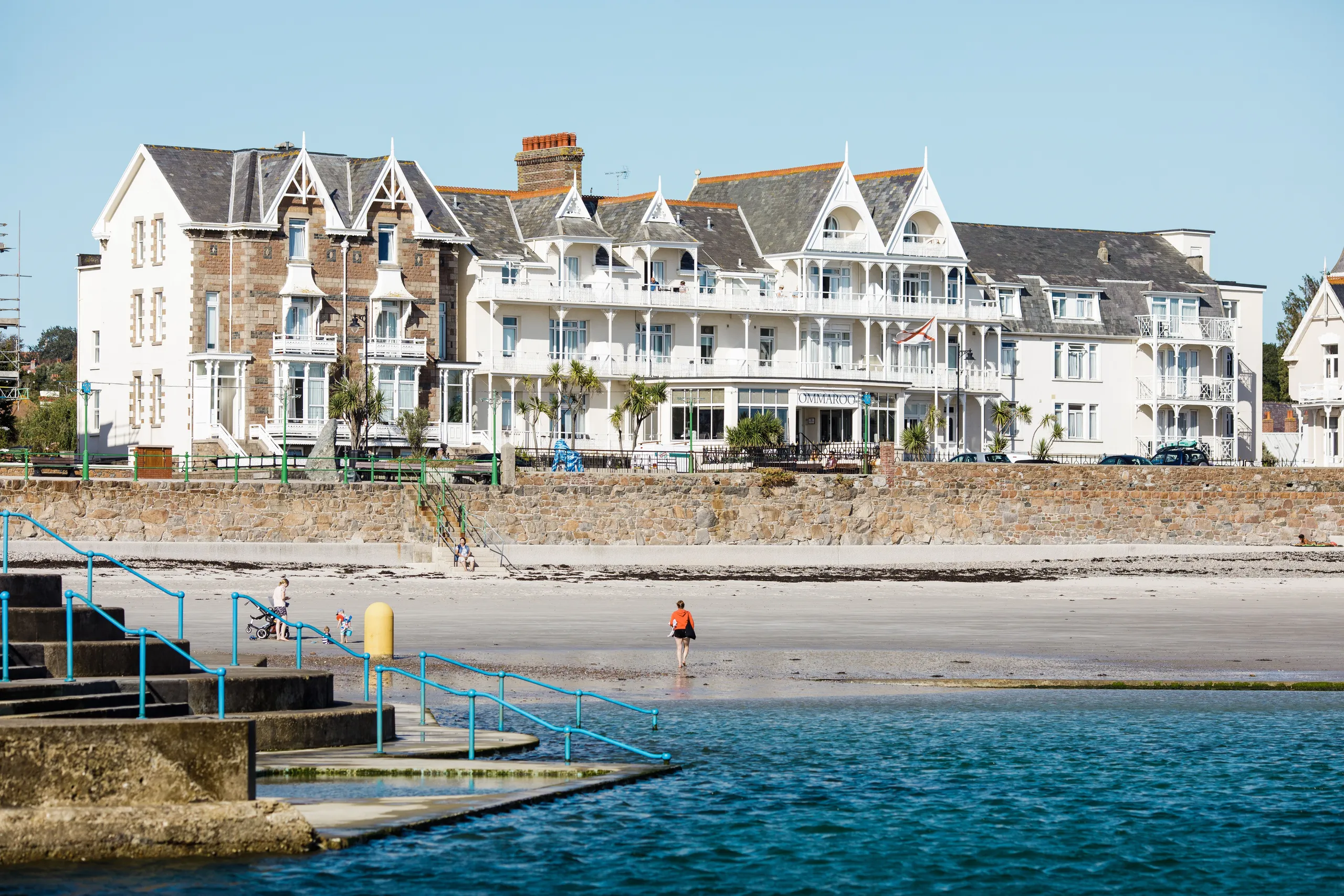 General view of Havre des Pas seafront with beachfront hotel buildings, sandy shore and sea pool steps in Jersey