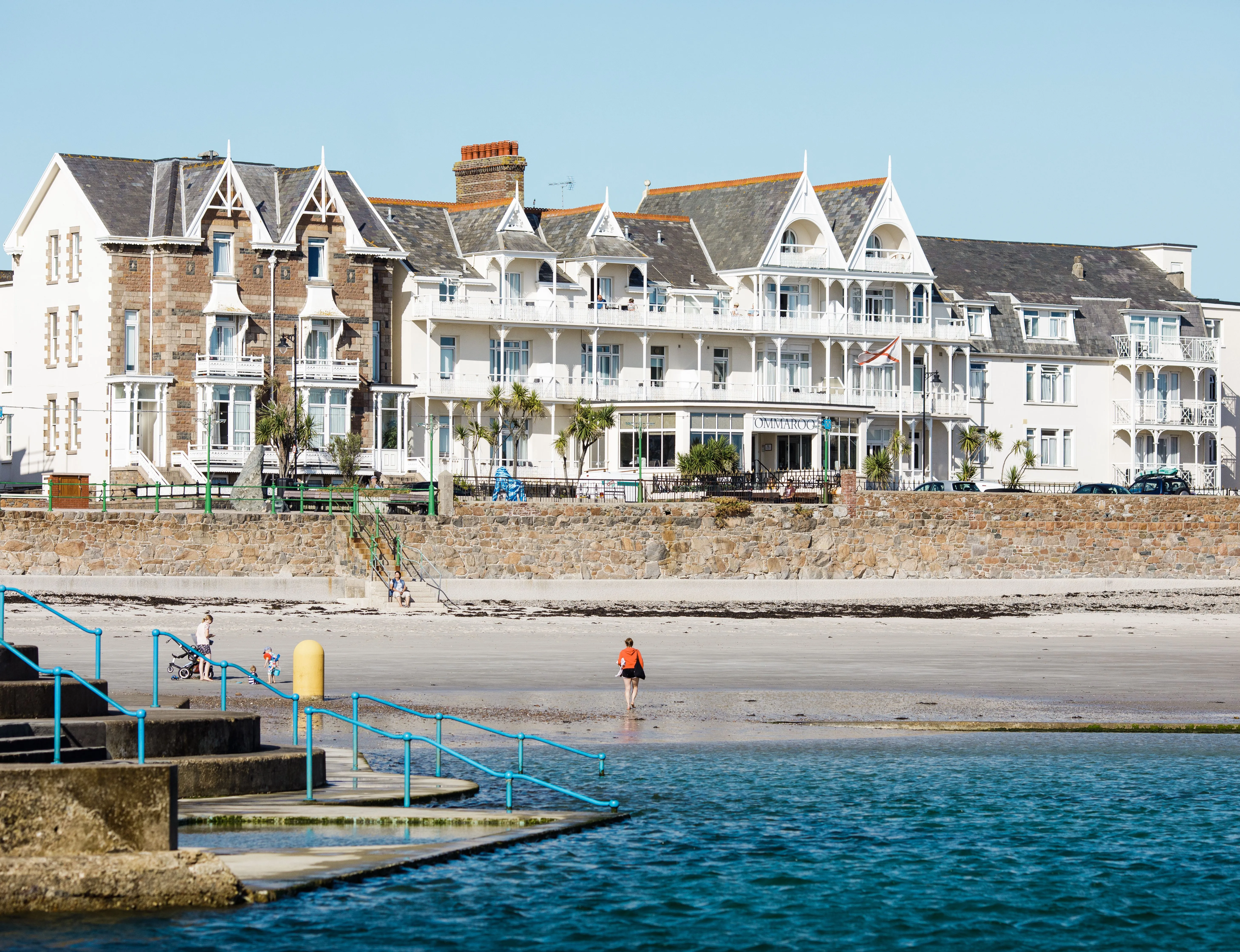 General view of Havre des Pas seafront with beachfront hotel buildings, sandy shore and sea pool steps in Jersey