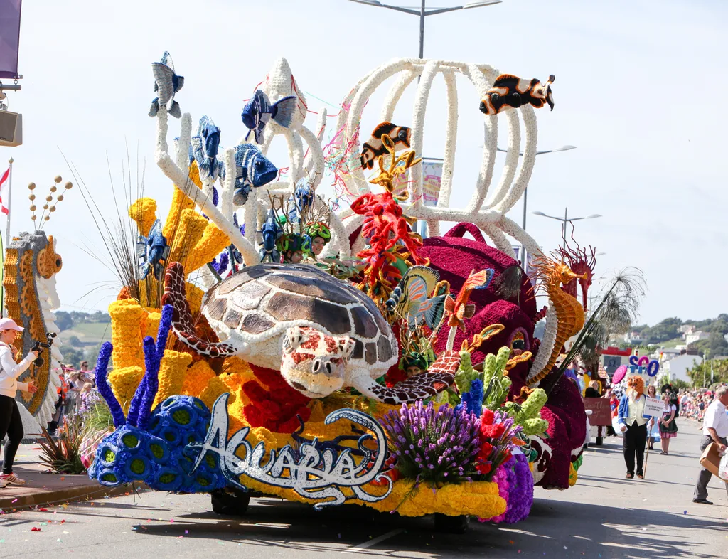 Colourful parade float with an underwater theme featuring a sea turtle, tropical fish, coral and sea horses