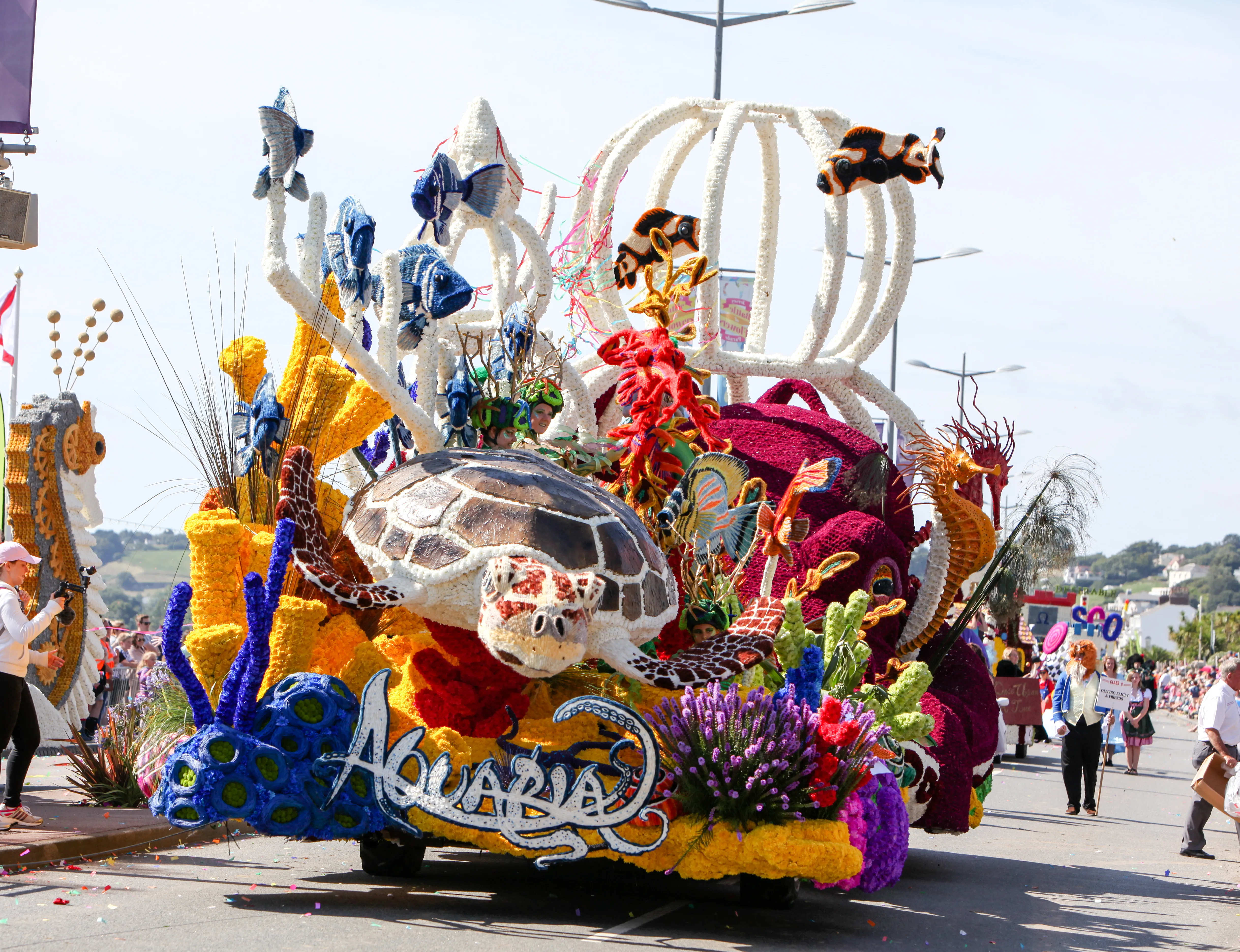 Colourful parade float with an underwater theme featuring a sea turtle, tropical fish, coral and sea horses