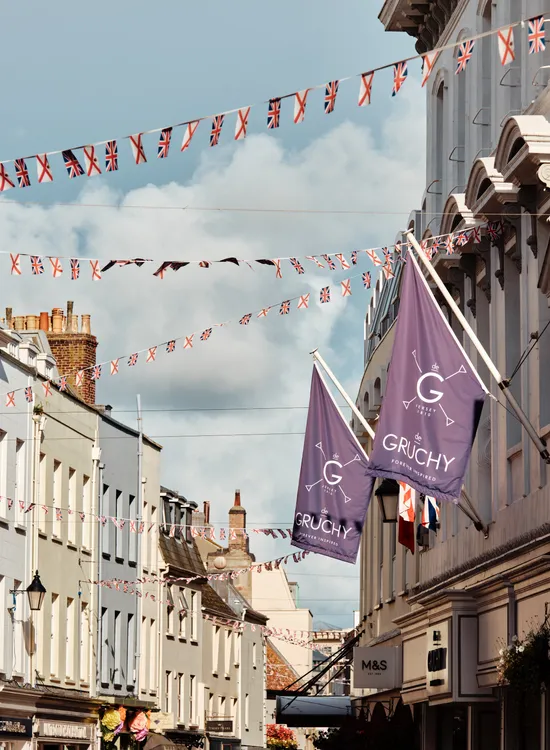 Street in Saint Helier, Jersey, decorated with Union Jack and Jersey flag bunting between historic buildings