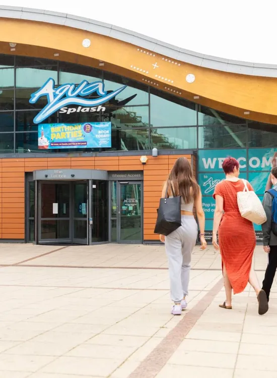 Visitors walking towards the entrance of Aqua Splash leisure centre