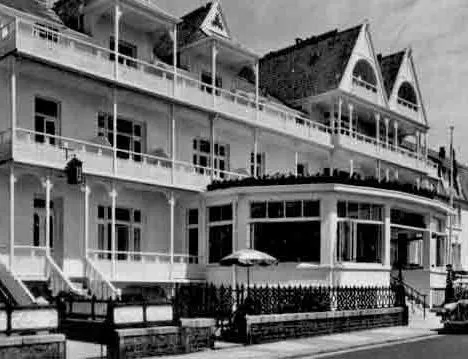 Black-and-white historic photograph of the Ommaroo Hotel with verandas and gabled rooflines beside a street.