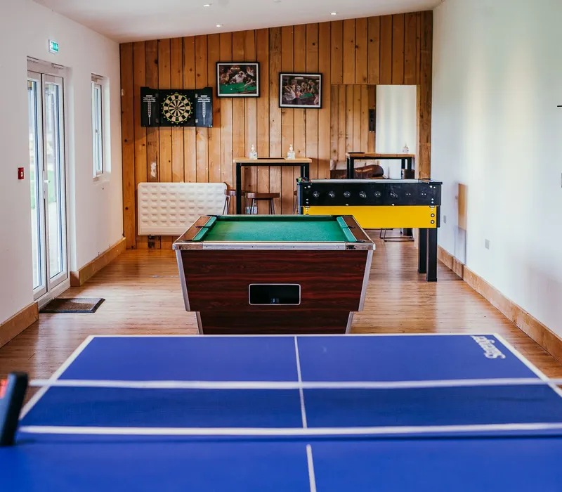 Games room with table tennis, pool table, dartboard and foosball table
