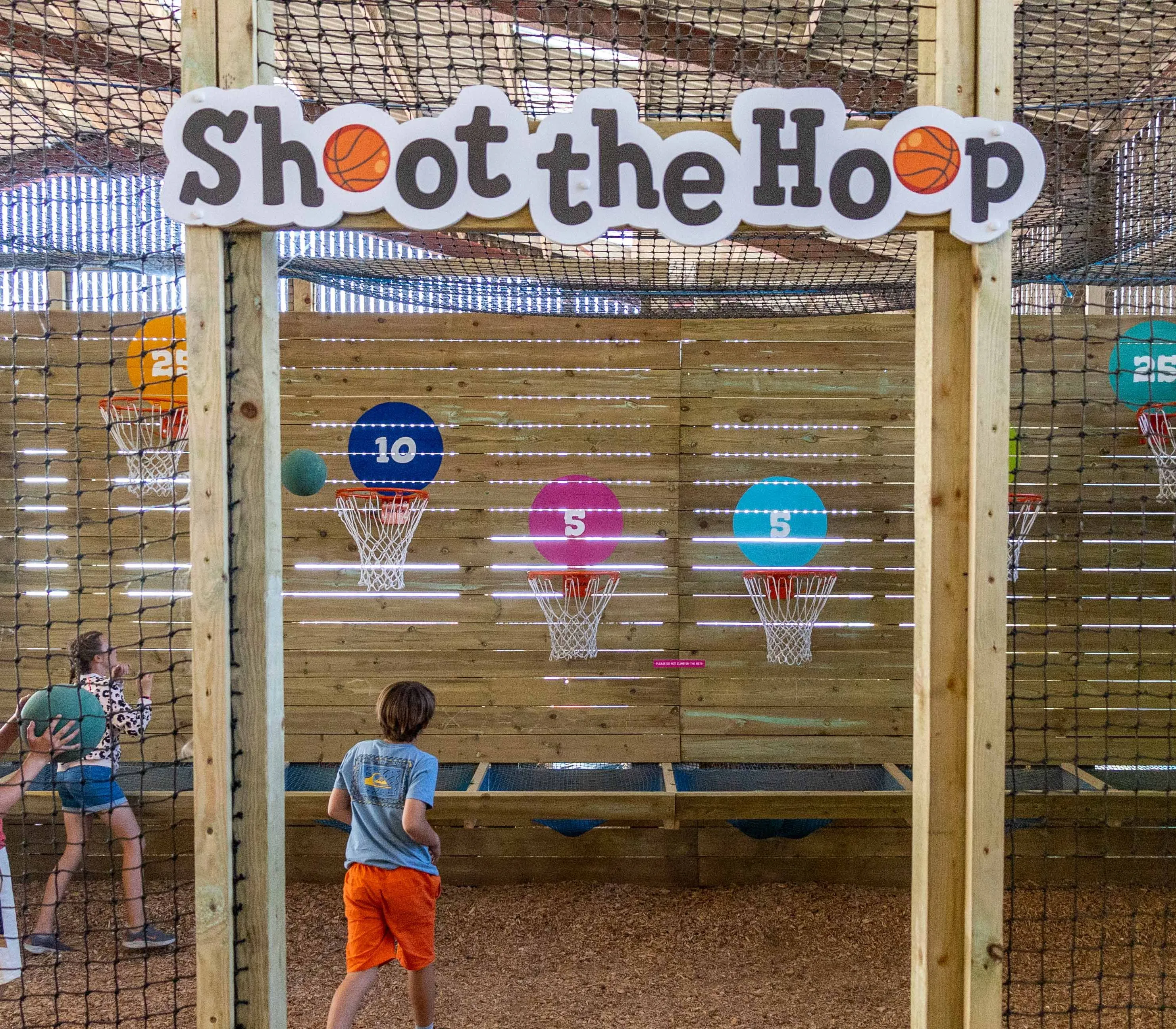 Children playing the Shoot the Hoop basketball game at Tapnell Farm Park