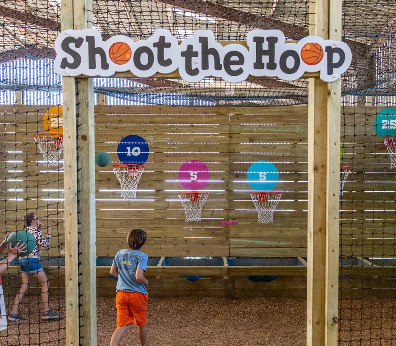 Children playing the Shoot the Hoop basketball game at Tapnell Farm Park