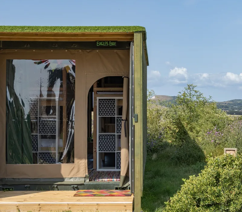 Safari-style glamping pod with bunk beds and countryside view at Tapnell Farm