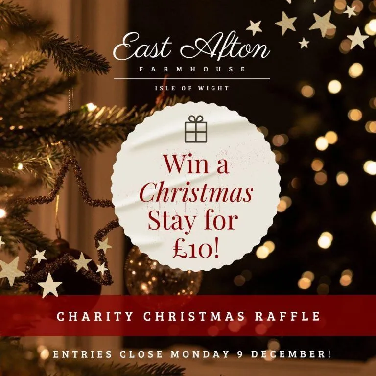 East Afton Farmhouse Christmas charity raffle post offering a chance to win a Christmas stay for £10, with festive lights and a decorated Christmas tree.