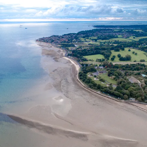 Aerial view of Appley Beach and the coastline near Ryde on the Isle of Wight at low tide, with calm sea, sandy shore and green countryside beyond.