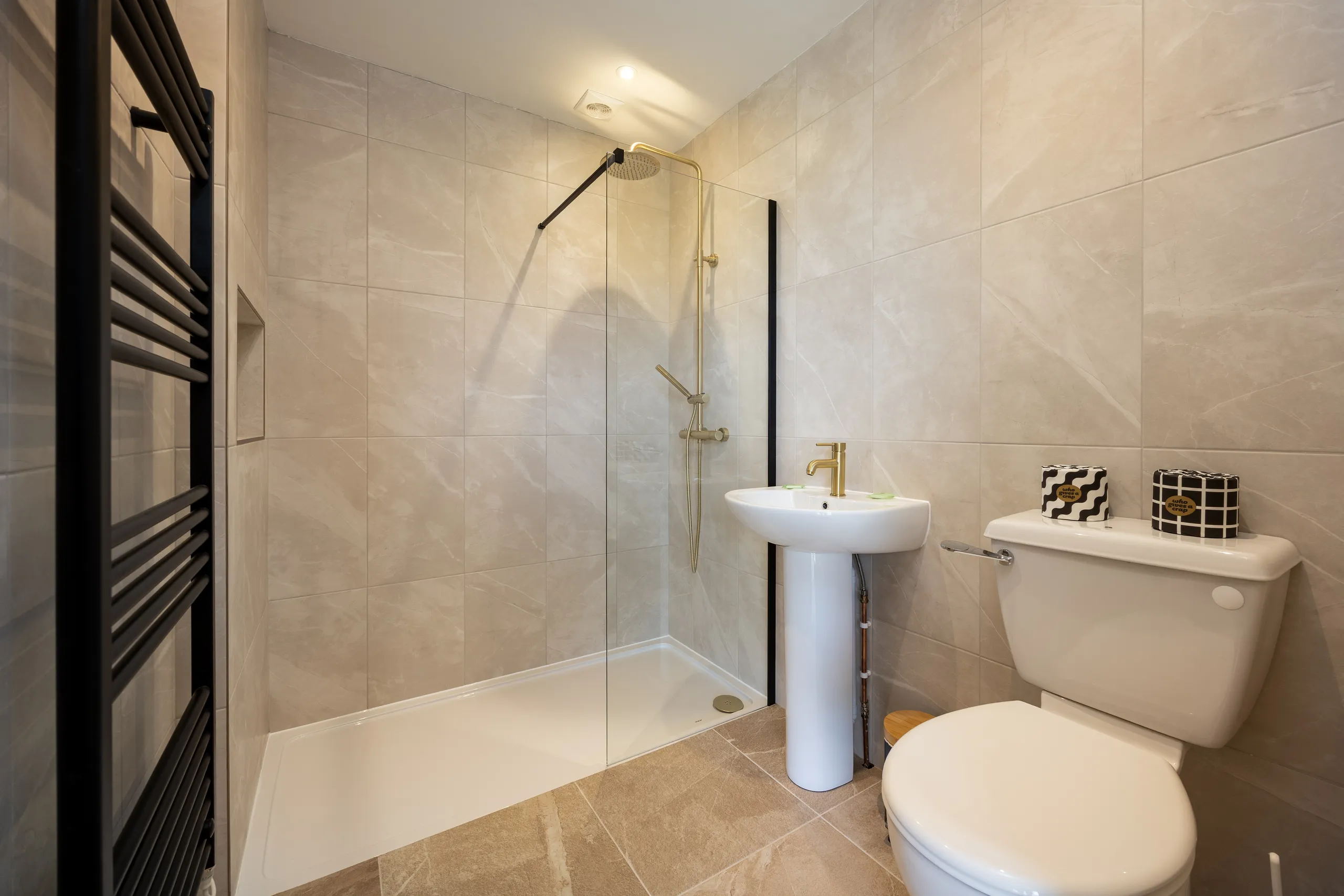Modern tiled shower room with walk-in shower, pedestal basin and toilet