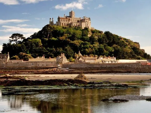 St Michael's Mount castle above the village and tidal shoreline in Cornwall