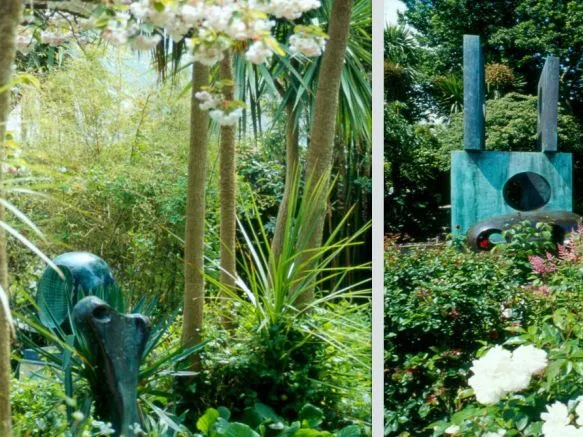 Lush garden with flowering roses, palms and abstract metal sculptures