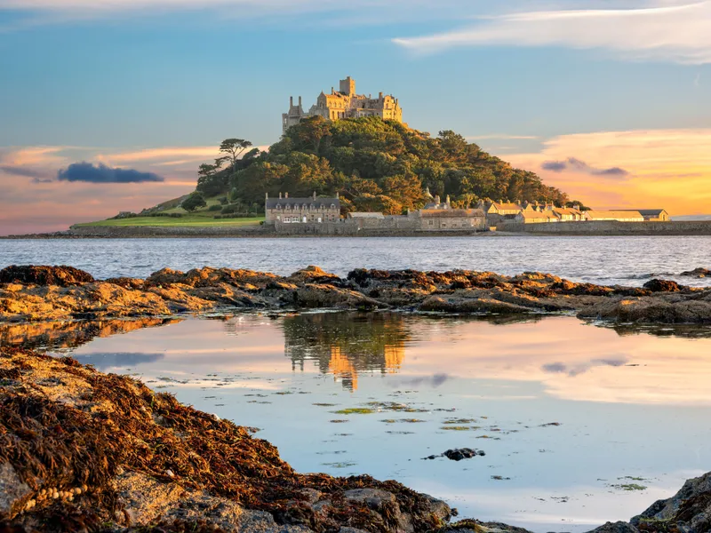St Michael's Mount castle reflected in a tidal pool at sunset, Cornwall