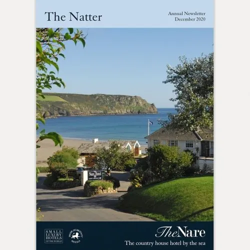 Cover of The Natter annual newsletter showing a coastal view from The Nare hotel towards a sandy beach and headland