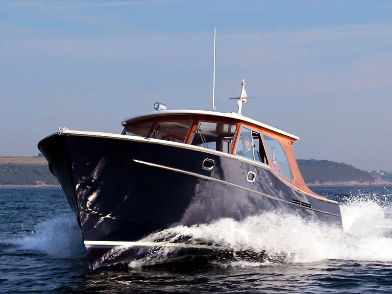 Alice Rose 9 motor launch speeding across open water near the coast