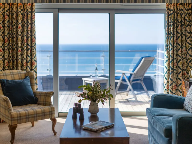 Elegant sea view suite lounge with balcony overlooking the ocean