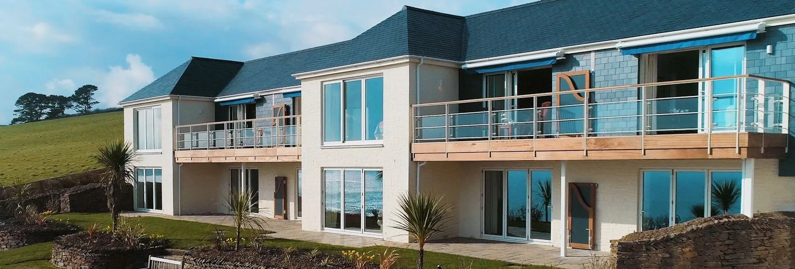 Exterior view of The Nare Whittington Suites with private balconies, large windows and landscaped gardens
